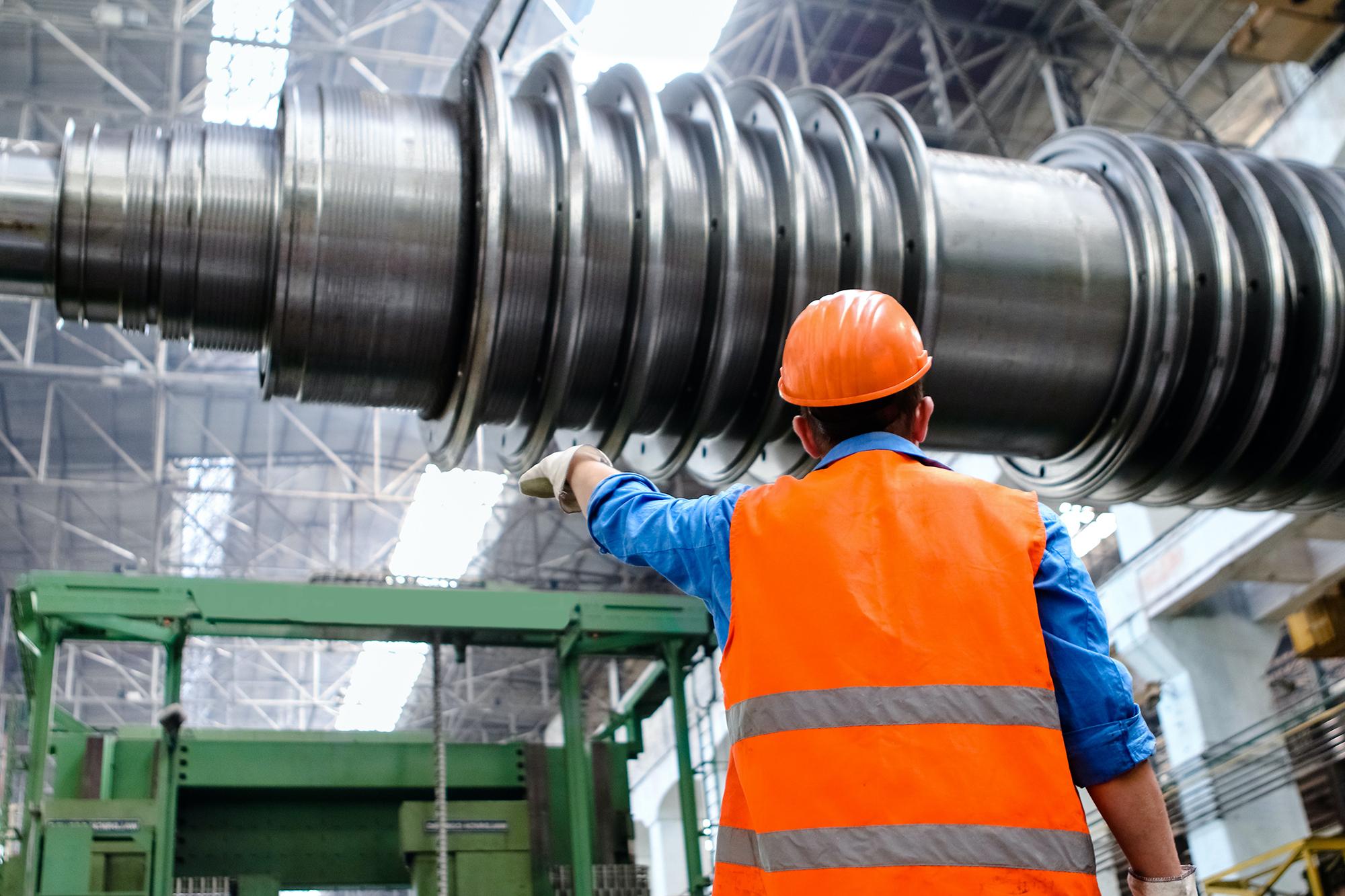 Engineer directing placement of large drill bit.